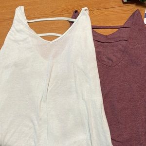 Two long sleeved shirts with straps across back